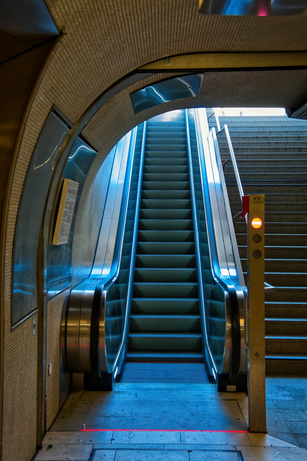 Escalator corridor in a contemporary industrial-style transit setting